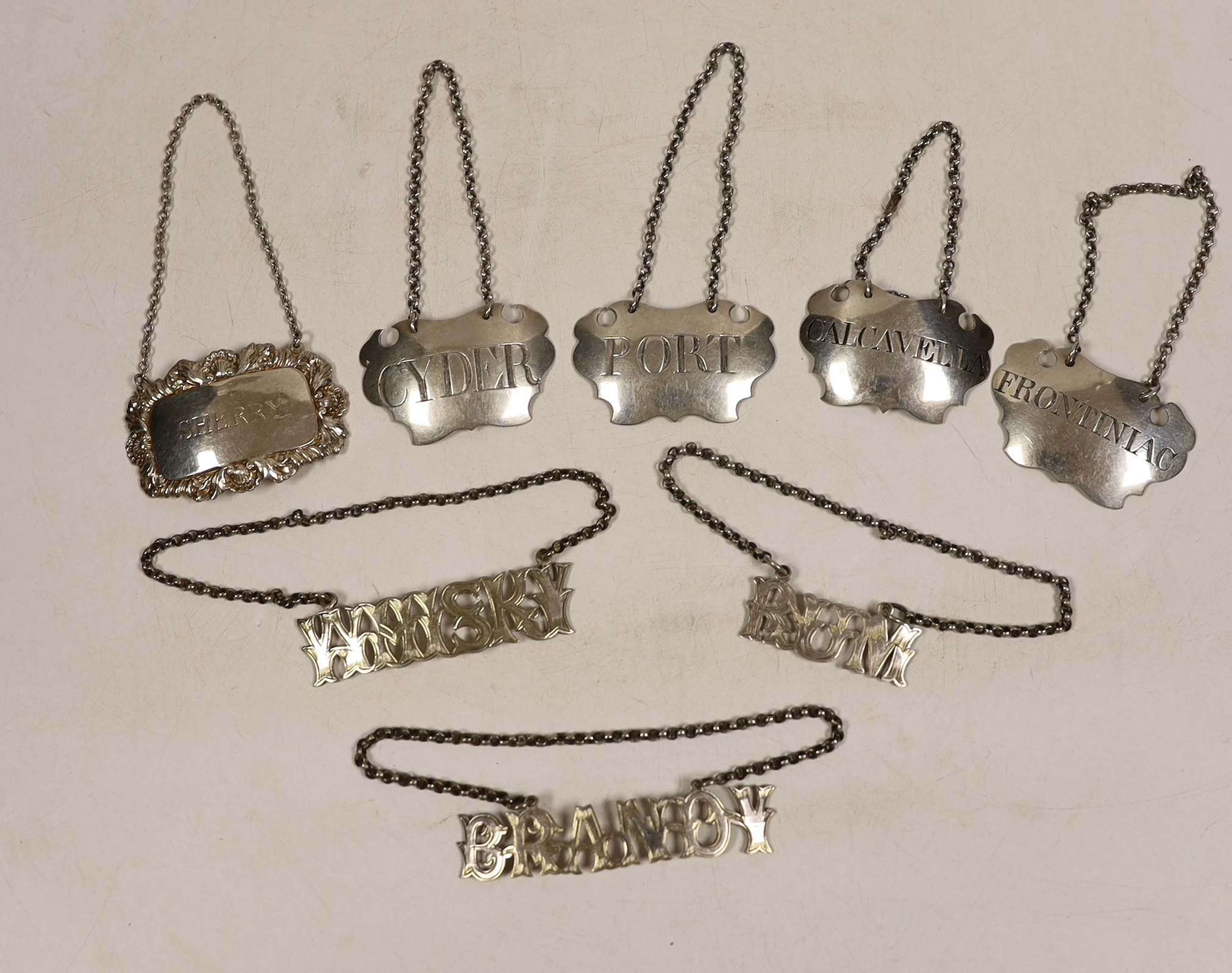 Four assorted 19th century white metal wine labels including pair 'Calcavella' & 'Port' by John Harvey I, London, circa 1750 and four assorted plated wine labels.
